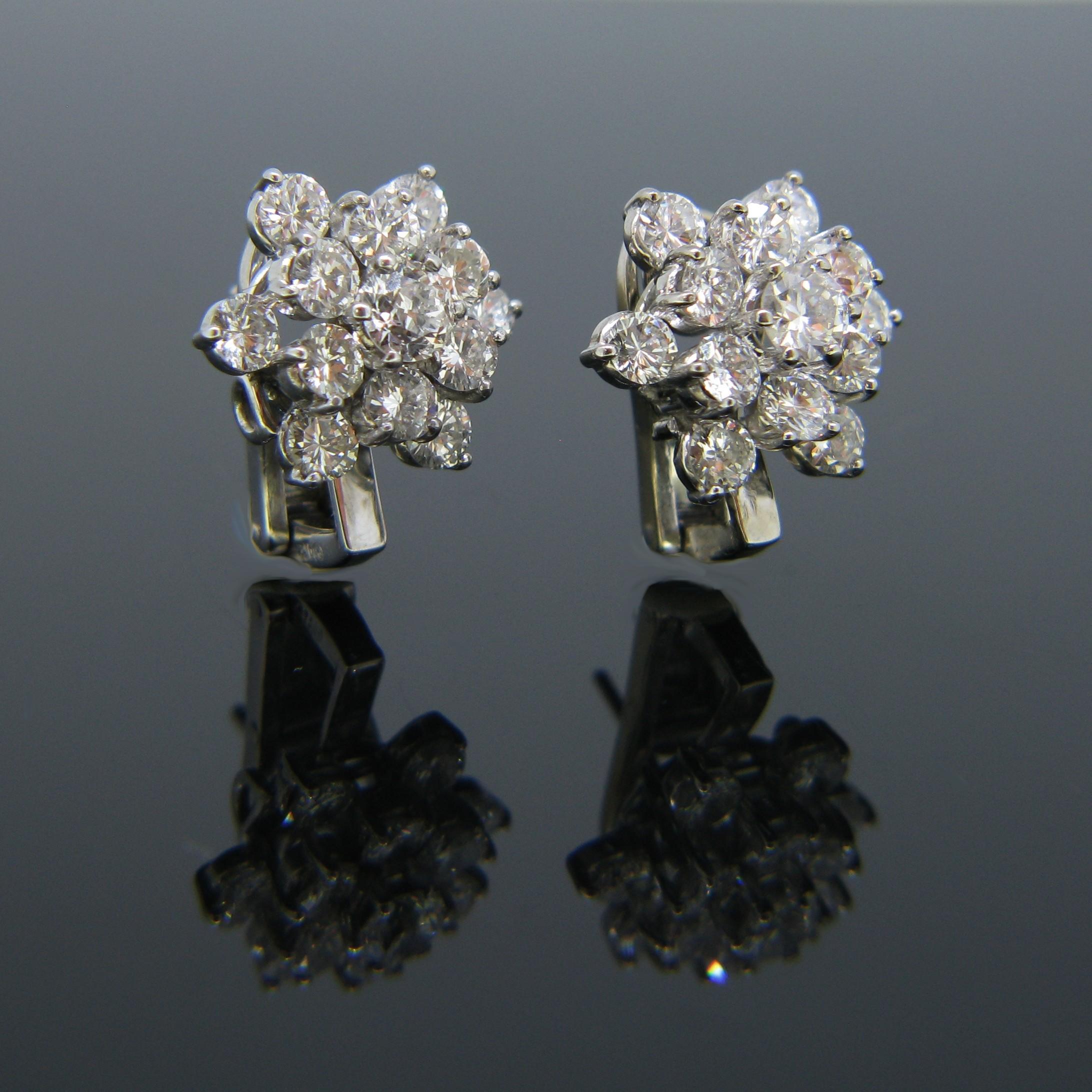 These lovely earrings feature 26 round cut diamonds with good colour and good clarity which adds up to a total carat weight of 3.70ct. The back is made in 18kt white gold and the diamonds are set in platinum. They are very comfortable to wear and