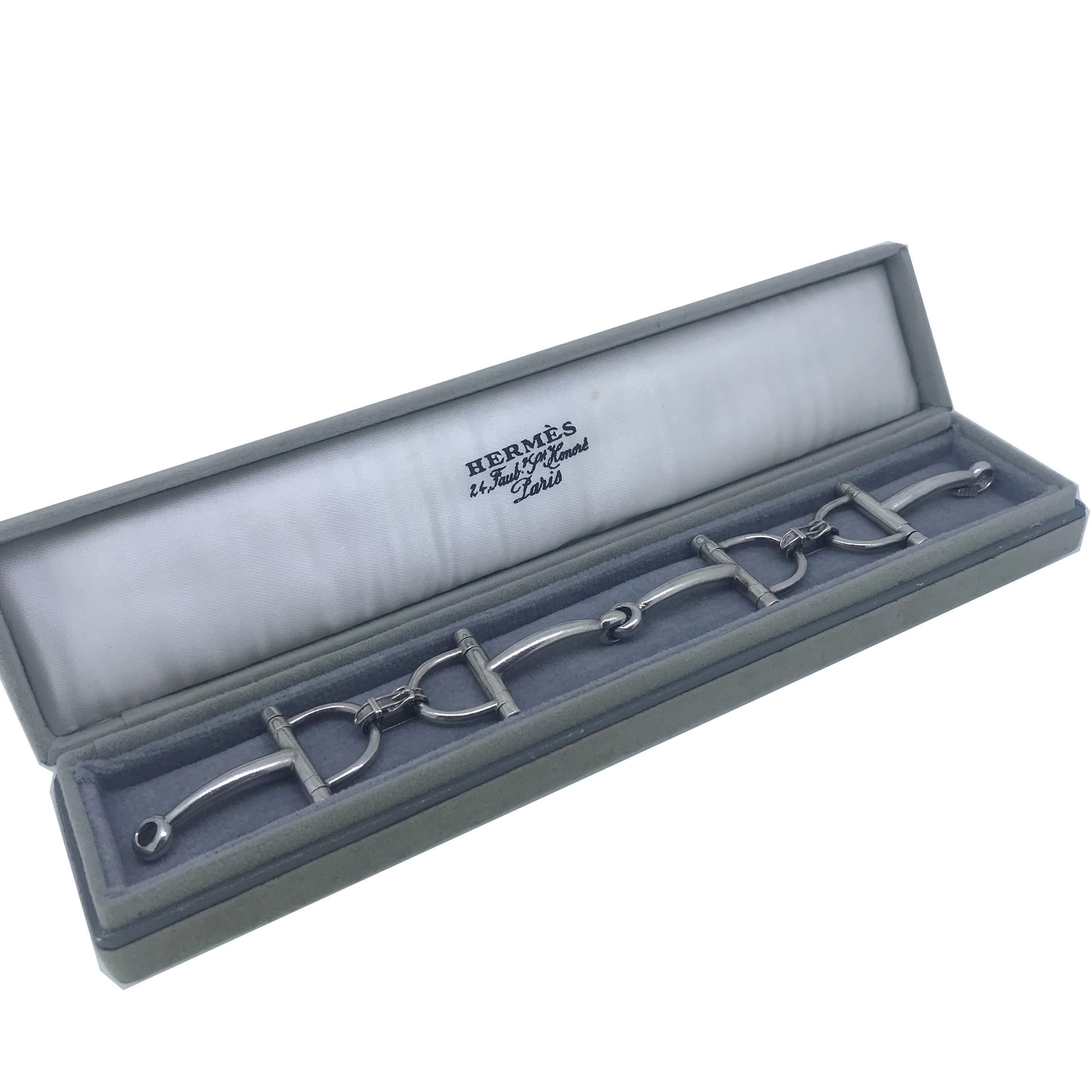 This vintage Hermes bracelet is fully made in Silver. It is marked with the French hallmark for silver and the maker’s mark. It is signed Hermes. The bracelet comes in its original Hermes box. It features the famous Etrier design with a buckle. It