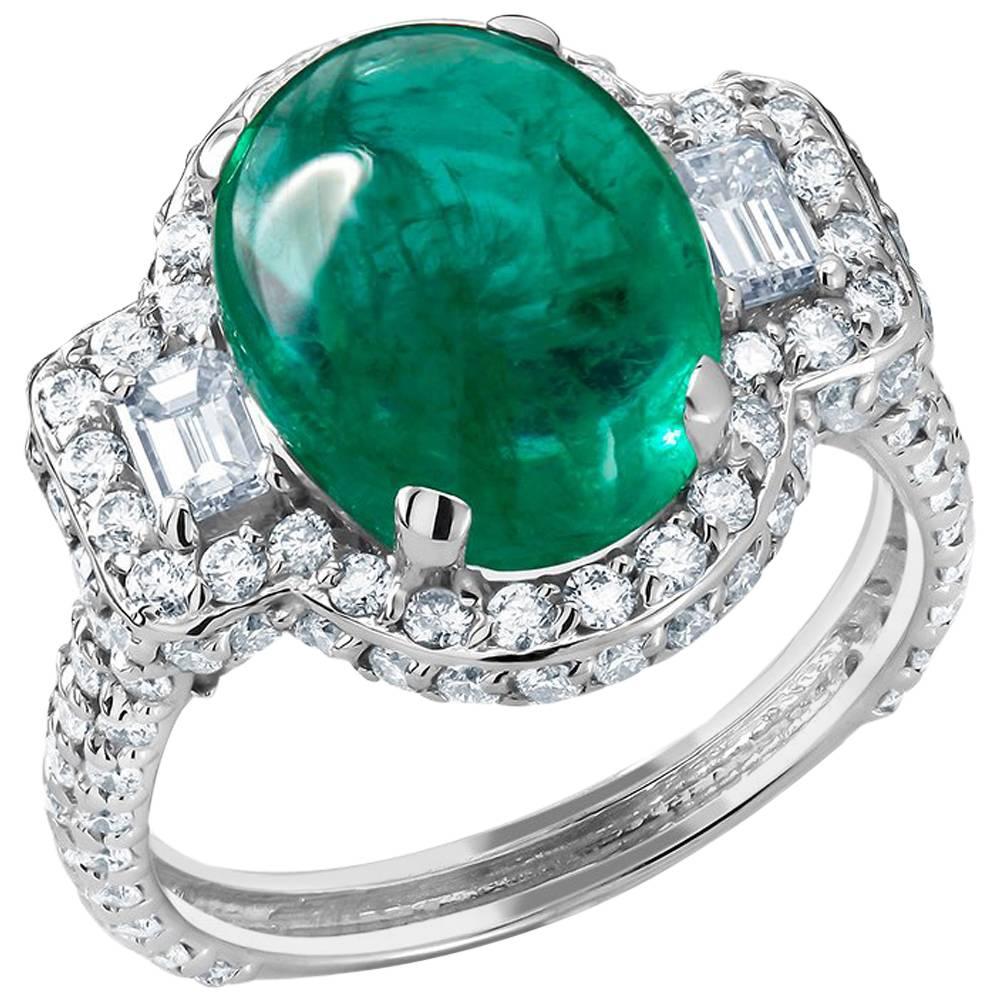 18k White gold cocktail cluster ring 
Colombian Cabochon emerald weight 5.20 carat 
Emerald cut shape diamonds side stones weighing 0.40 carat 
Surrounded by pave-set diamonds weighing 1.75 carat 
Diamond quality G VS
One of a kind ring 
Ring size