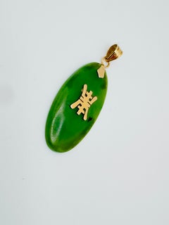 14 Karat Yellow Gold Oval Cabochon Jade with Symbol