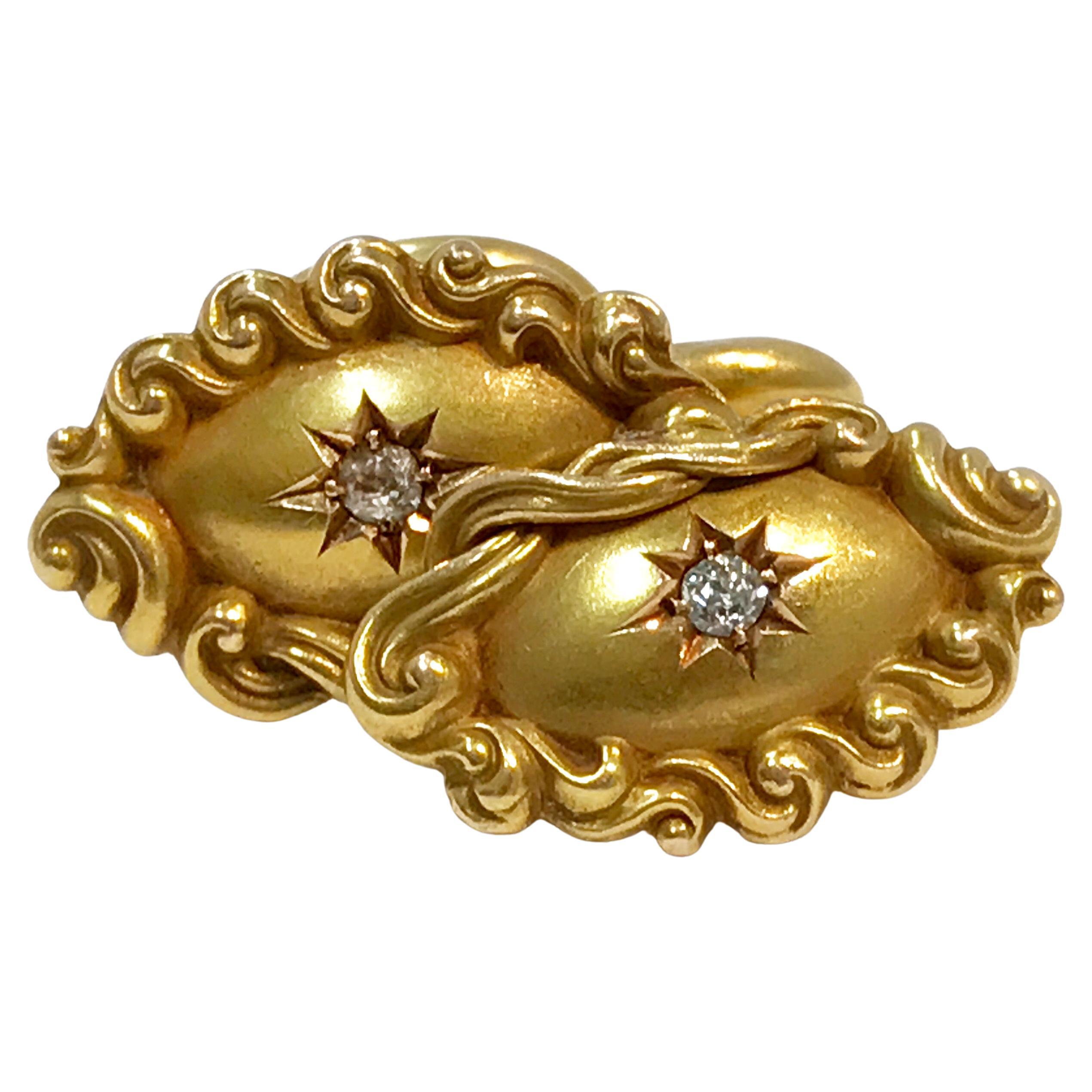 Victorian 10K Gold Oval Cufflinks, Star Set Diamond Center 0.06 carat. A pair of Victorian 10K yellow gold cufflinks featuring oval shaped fronts with scroll design, star set diamond centers, prong set. The cufflinks have fixed bean backs which are