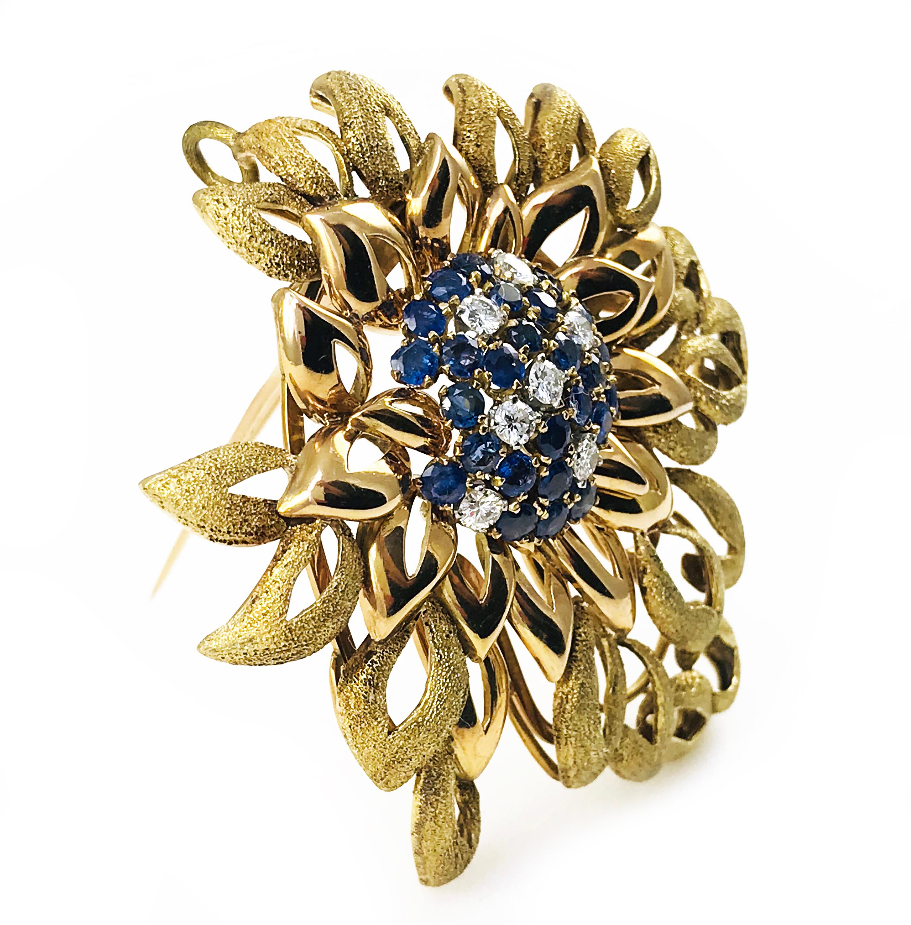 14 Karat Rose and Yellow Gold Flower-Shaped Natural Blue Sapphire Diamond Pendant Brooch. The brooch features seven round diamonds and twenty-six round blue sapphires. The individual flower petal outlines are smooth closest to the center and