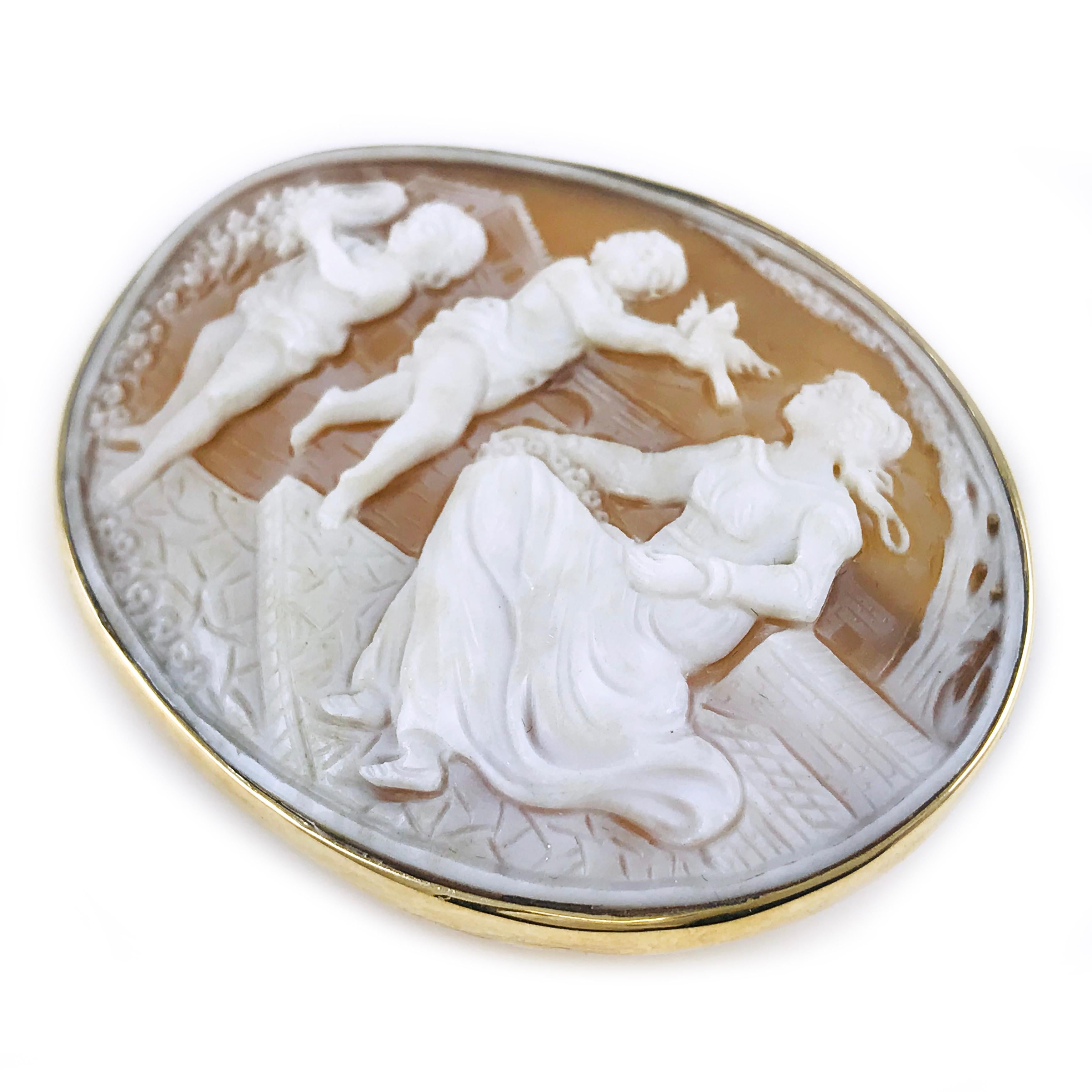14 Karat Yellow Gold Carved Shell Oval Bezel Cameo Brooch Pendant. Portrait of Mother and two children meticulously carved by an artisan in Italy. The gold bezel follows the shape and depth of the piece, a 14mm hinged enhancer and a 40mm pin on the