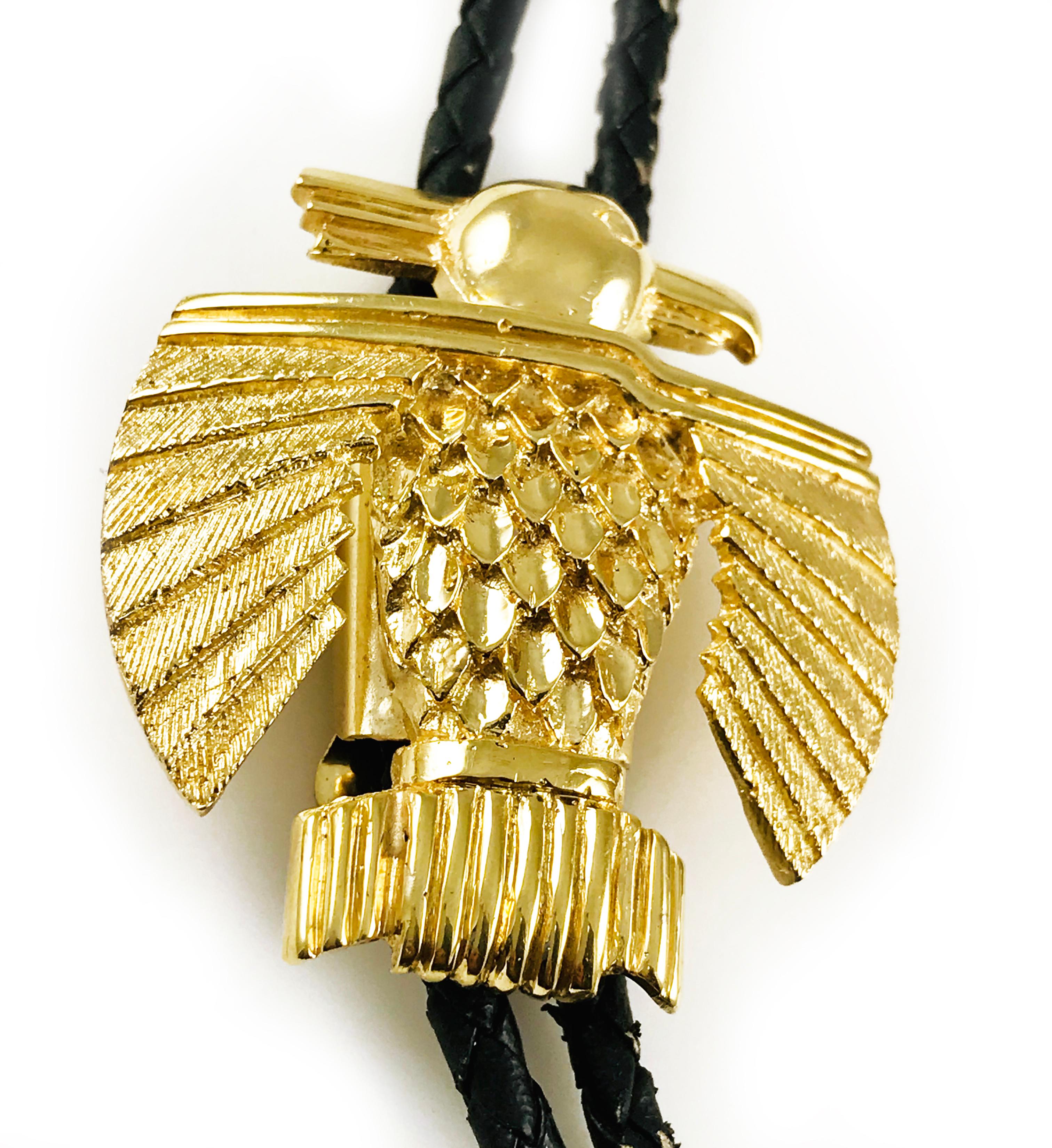 Art Deco-Inspired handmade 14 Karat Yellow Gold Native American Thunderbird Bolo. The black leather cord is 3.5mm wide and shows some wear however, this is a truly stunning piece. The Thunderbird measures 1.75