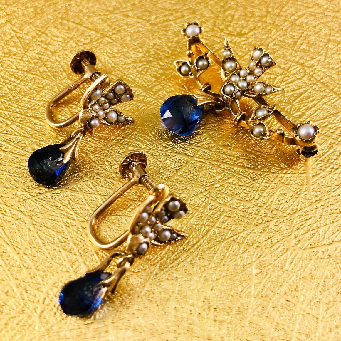 Victorian 14 Karat Bird Briolette Sapphire Seed Pearl Pin and Earrings. This lovely set of three birds evoke timeless elegance, each bird features seed pearls in sizes 1.5-2mm and one teardrop briolette blue sapphire held on by a flower shape pinch