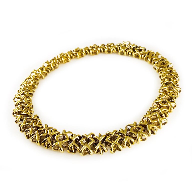 18K Gold Crisscross Link Necklace. This stunning heavyweight neck is a statement piece. The necklace is 17.5 inches long.