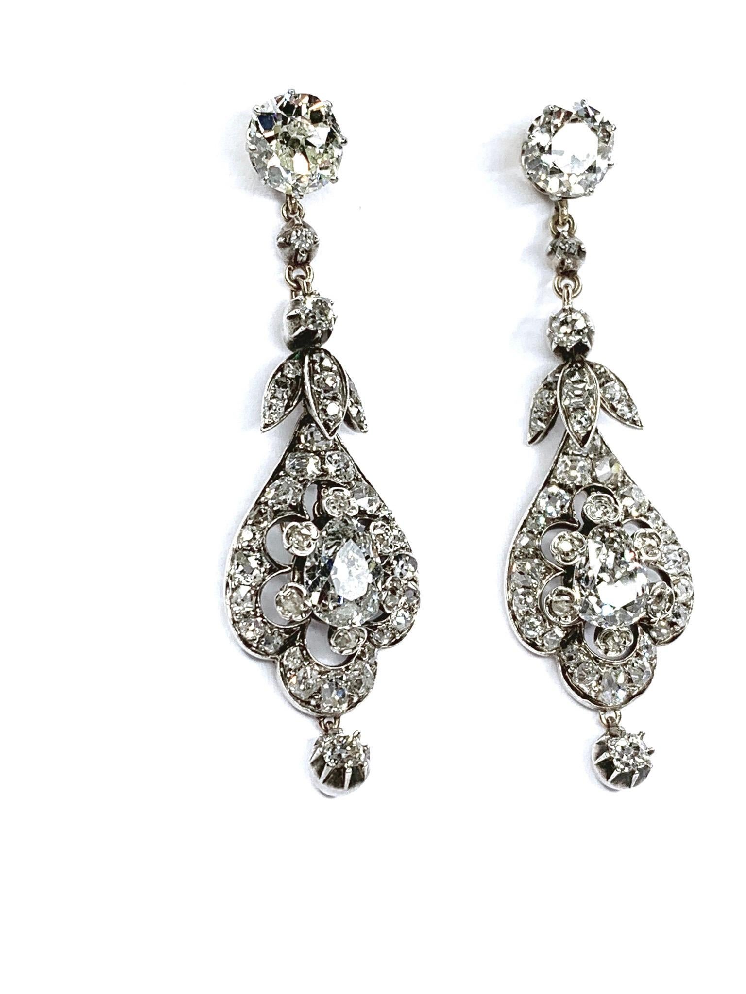 Antique Pair of Diamond Earrings, Cushion Shaped Diamonds estimated weight 1.70 & 1.80 carats, estimated color I-J & clarity VS2. Pear shaped diamonds estimated weight 1.25 & 1.38 carats, estimated color I-J & clarity I. in silver and 18K gold.