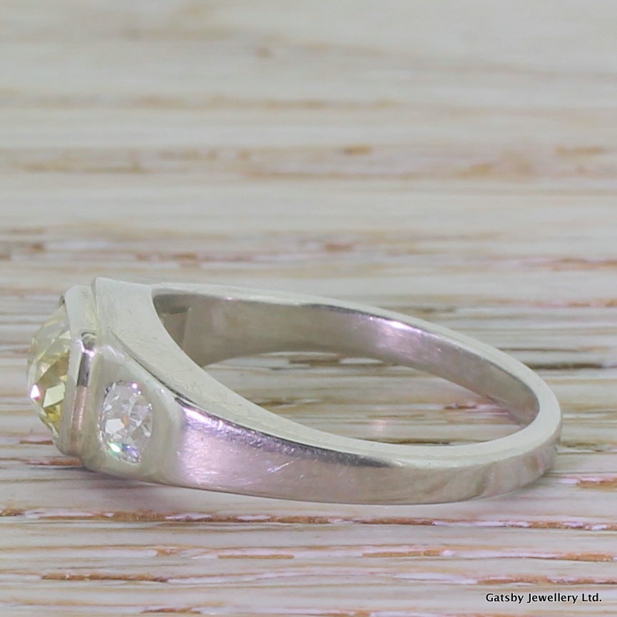 Art Deco 1.11 Carat Natural Fancy Yellow Old Cut Diamond Platinum Trilogy Ring In Excellent Condition In Theydon Bois, Essex