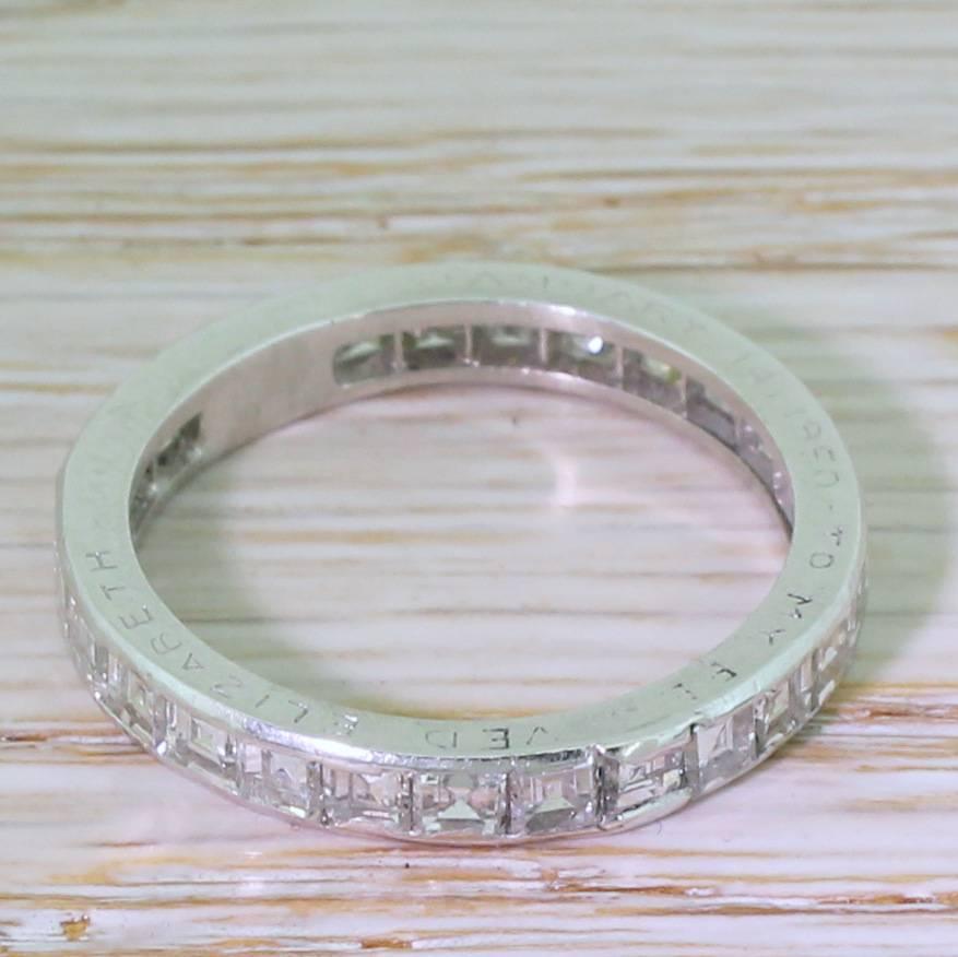 Impossibly lovely. This gorgeous eternity ring is features twenty-five high white and internally clean carré cuts diamonds, channel set in platinum. Would work equally well stacked with an engagement ring as it would on its own. A small piece of