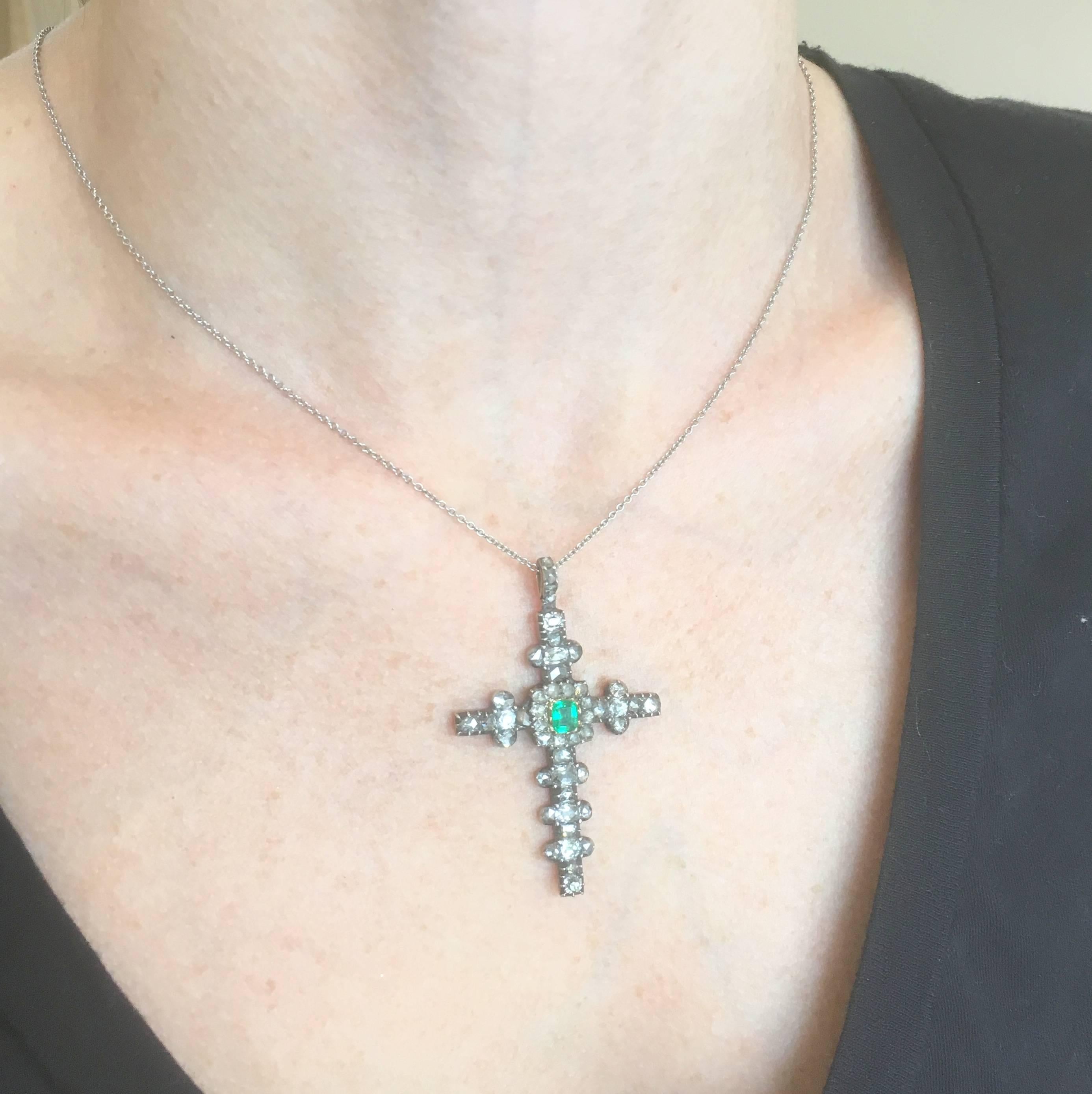 A spectacular cross pendant which bursts with history and character. At the cross’s heart is a bright, verdant green emerald set in yellow gold, with ten rose cut diamonds in the immediate surround. The ornate, stylised arms are encrusted with eight