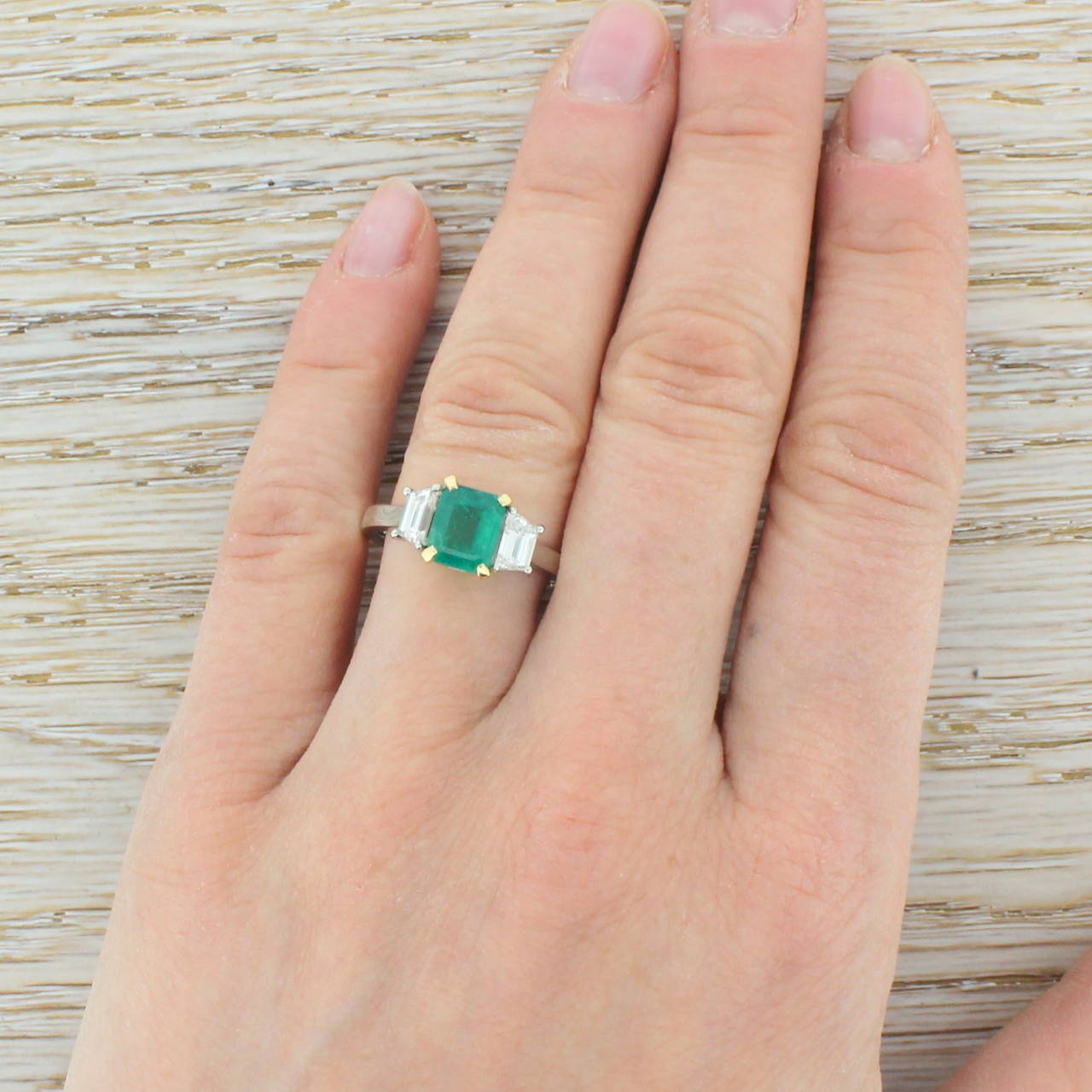 Emerald and Trapeze Cut Diamond Platinum Trilogy Ring In Excellent Condition In Theydon Bois, Essex