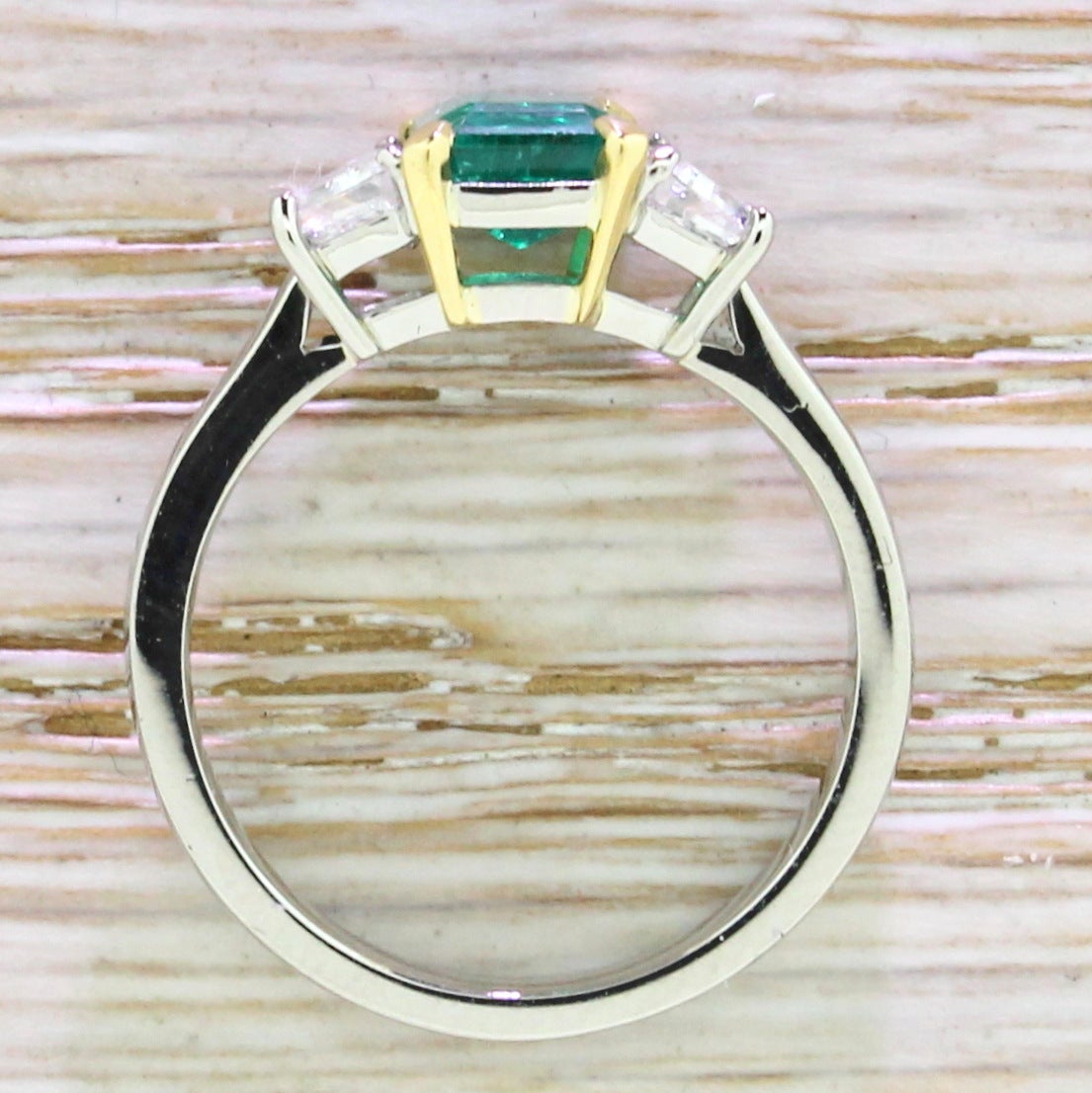 Modern Emerald and Trapeze Cut Diamond Platinum Trilogy Ring