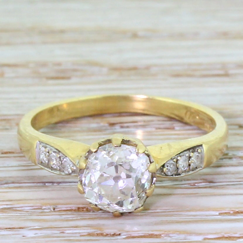 A fine and lively Victorian old cut diamond set in a fantastic mount from circa 1965. The central diamond is held in a unusual and striking ten-claw closed-back basket collet. Six (three either side) eight cut diamonds are set in the tapering