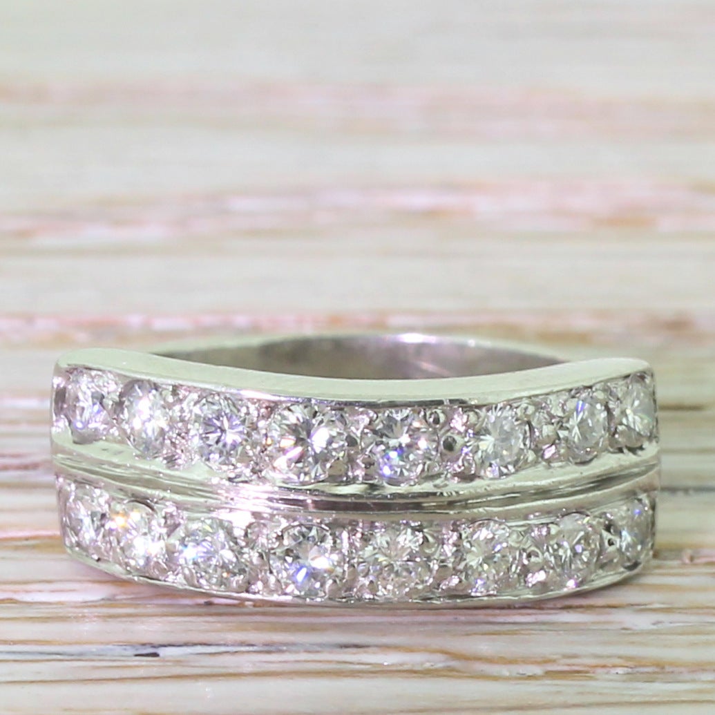 A very cool, very versatile and very beautiful late 20th century diamond ring. A simple but neat design has two rows of eight white and bright brilliant round cut diamond set parallel to each other on a split shoulder flat band. A extremely wearable