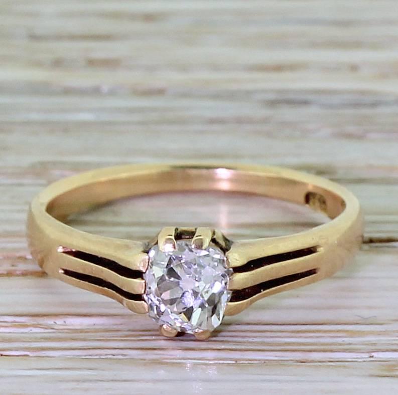 This delightfully unusual Victorian solitaire ring features a a bright and lively cushion shaped old mine cut diamond. The neat vented shoulders split into three and lead to a shallow D-shaped shank.

Cut – Cushion shaped old mine / miner