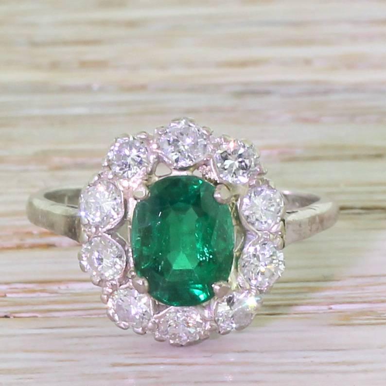 Our hearts nearly stopped when we saw this emerald. This perfect blue-ish green gem somehow glows in a way other emeralds don’t. Ten pure white diamonds encircle the oval cut emerald, emphasising the luscious and deeply saturated centre stone. Truly
