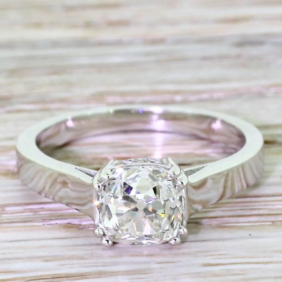 A wonderful diamond in a setting that, although simple, holds a few fine and classy details. The cushion shaped stone is laterally set in a four double claws leading to a wonderfully detailed gallery, all atop a nice and substantial flat band.