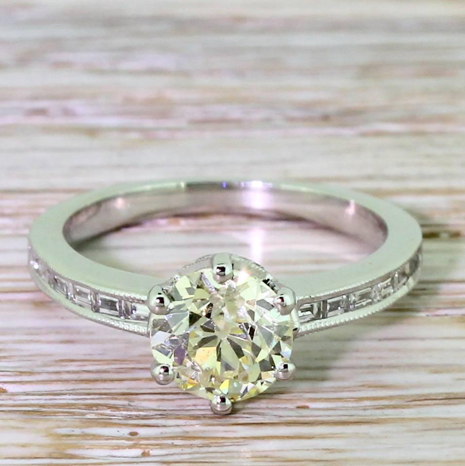An absolutely breathtaking diamond showcased in an equally impressive mount. The old mine cut in the centre is fancy light yellow and dazzlingly bright and vibrant. Secured in a six claw collet which features ten brilliant cut diamonds in the