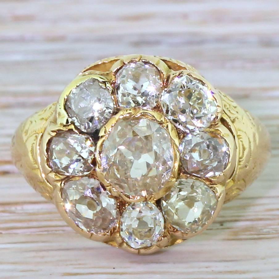 An immense Victorian cluster. The centre diamond is conservatively estimated at 0.90 carat, with a further eight generously proportioned old cuts in the surround. The wonderfully imperfect hand-cut diamonds are set as low to the finger as their size