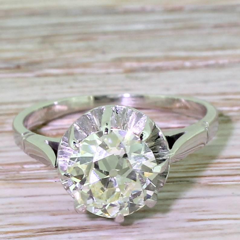 A bright and super sparkly old European cut diamond engagement ring. The diamond is secured in a platinum eight-claw open collet with a scalloped back setting, leading to a tapering 18k white gold shank. A simple, unfussy setting which perfectly