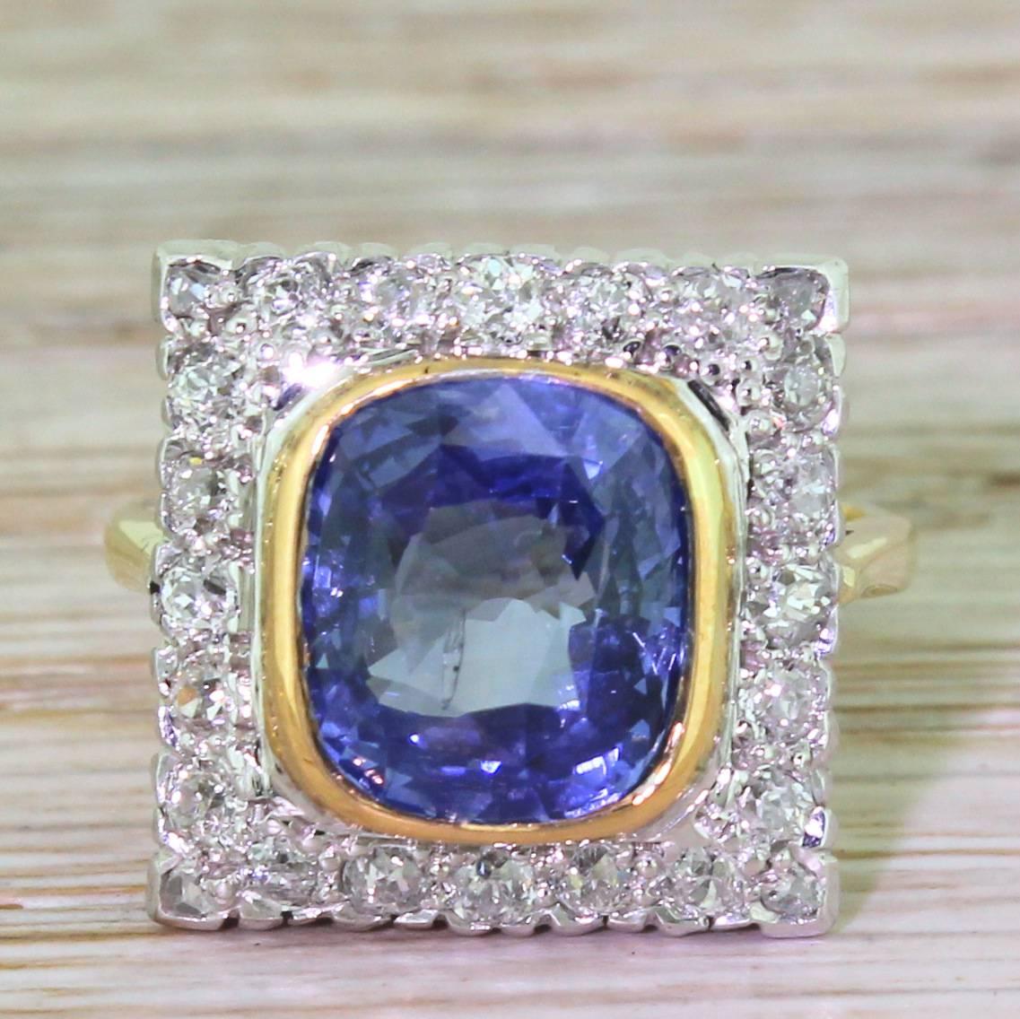 This is exceptional. The natural Ceylon sapphire is a wonderfully rich and bright blue, and is rubover set in rose gold. The cushion shaped stone is set in a square gallery, with twenty old cut diamonds in the surround and four rose cut diamonds in