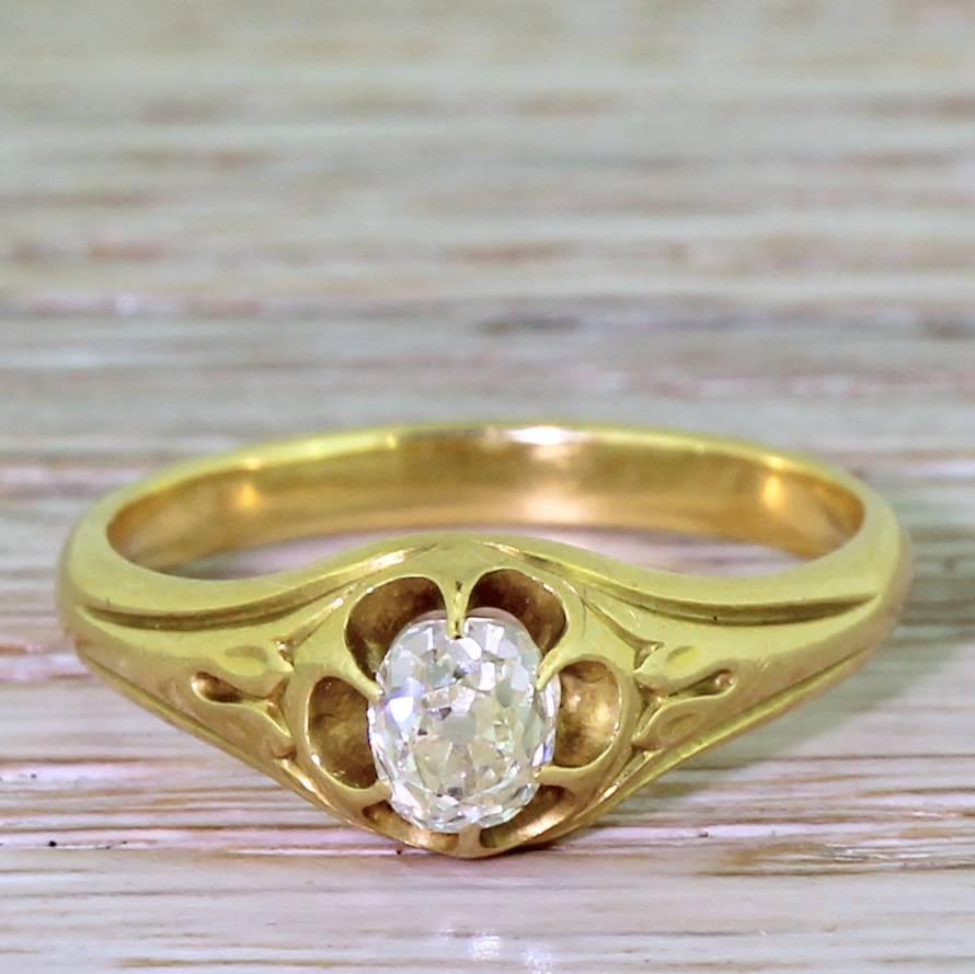 A gorgeous late Victorian solitaire ring. The cushion shaped old cut diamond displays an impressive amount of fire and brilliance. Six fine claws hold the stone in an open gallery, leading to decorative shoulders to a substantial D-shaped shank. A