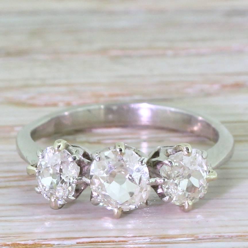 A fabulous trio of old cut diamond. The stones are bright, lively, internally clean and all a matching light champagne hue. The central cushion shaped stone is slightly larger than the oval shaped old cuts eight side. Each diamonds secured in an