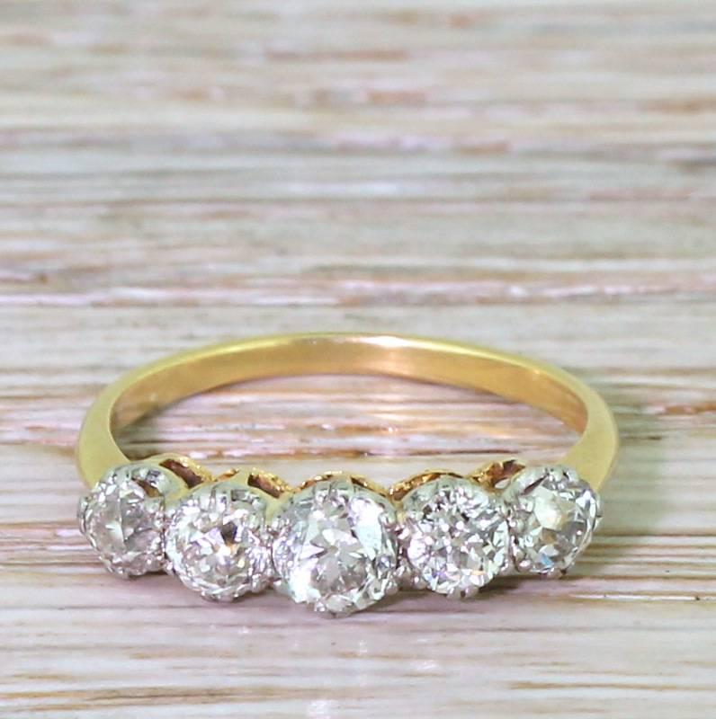 A wonderful five stone ring. The slightly graduating line of old cut diamonds are of exceptional quality; high colour and very good internal clarity. Sitting nice and low to the finger, the diamonds are secured in platinum double claws within a
