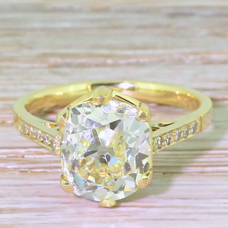 A huge - and hugely impressive - diamond solitaire. The central stone weighs in at hefty 3.66 carat and displays a distinct yellow hue. The irregularly shaped diamond, most likely cut and polished in the mid-Victorian era, is set a striking and
