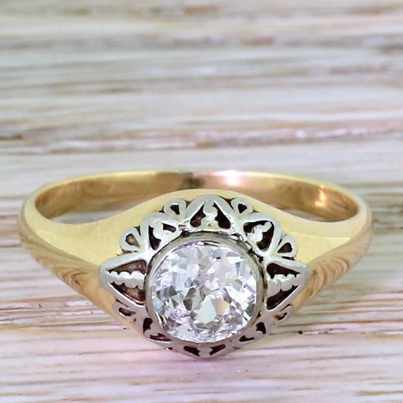 So deeply pretty. The old cut diamond is high white, bright and full of life and fire. The diamond is rubover set and surrounded by gloriously ornate white gold detailing which adorns a classic, Victorian style solitaire ring.

Accompanied by an