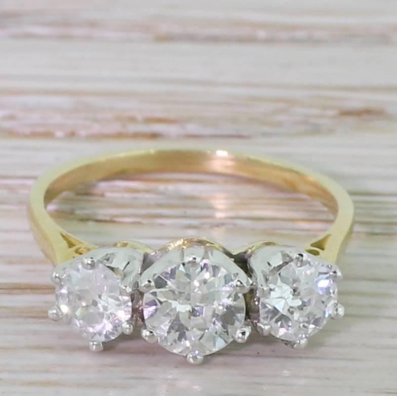 A beautifully balanced trilogy ring. The bright and lively old European cut diamonds are each secured in six claw “crown” collets, leading to a slim yellow gold shank. Classic and striking.

Accompanied by an independent jewellery report. Please