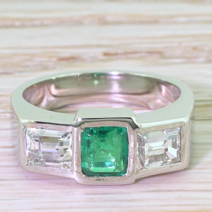 Sleek and sublime. The square step-cut emerald is the ideal blueish green with plenty of life and lustre, and is set between two large baguette cut diamonds – high white, internally clean and incredibly bright. The three high quality gems are