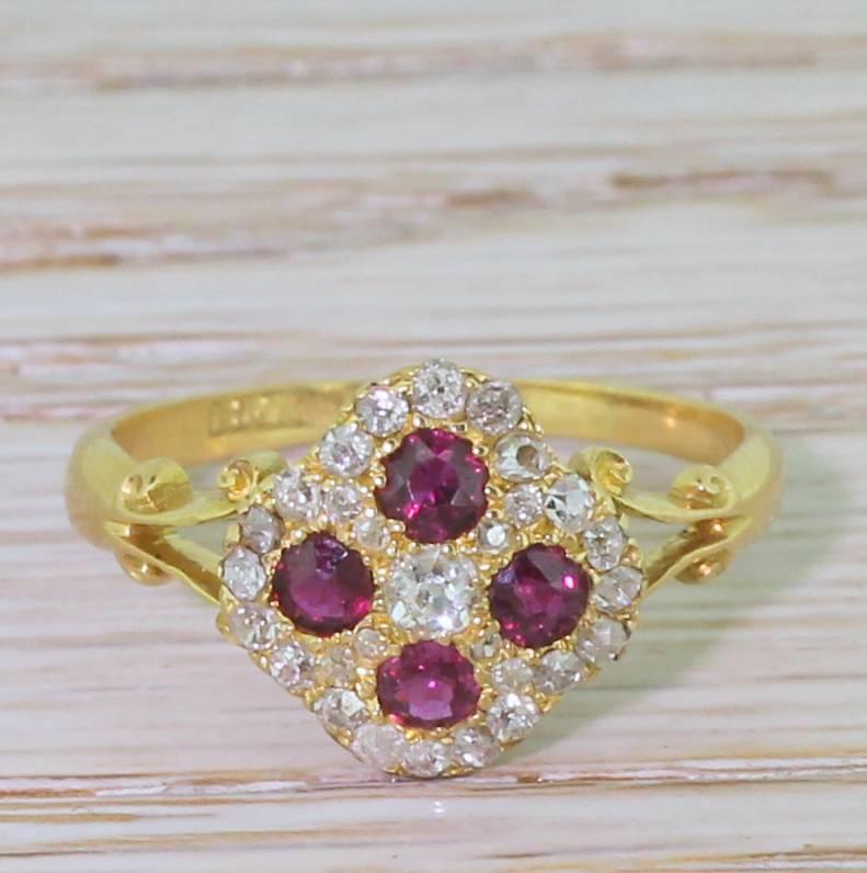 Exceptional. Four bright pinkish red rubies are set with in a cluster of twenty-nine high white old cut diamonds. The incredibly intricately made head features delicate piercing in the gallery, leading to ornate split shoulders. A