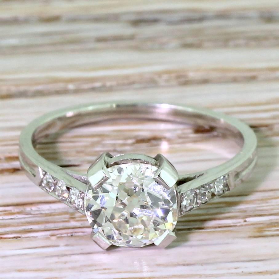 A lovely, lovely diamond solitaire. The very lively old cut diamond rests in a wonderfully stripped back setting. Four flat claws secure the centre stone with an open, double gallery allowing maximum light to pass through the stone. The slender