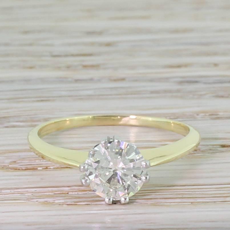 Beautiful and subtly unique. The extremely sparkly transitional cut diamond is secured in platinum collet featuring four split double claws, with geometric detailing in the gallery leading to an ultra slender 18k yellow gold knife-edge shank. Pure