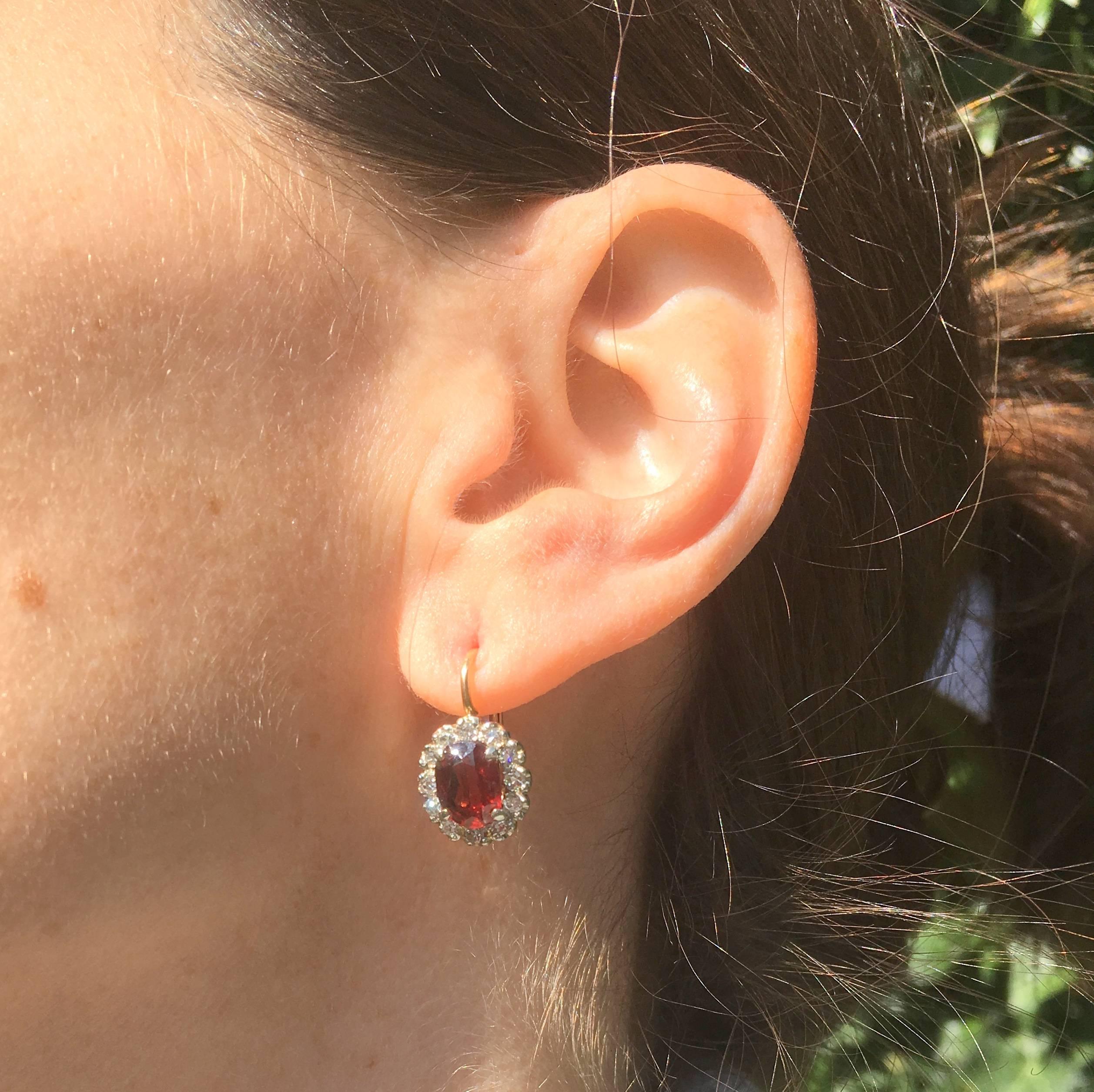 A fine and elegant pair of earrings. The natural and unenhanced rubies – most likely of Thai origin – are secured by four claws and halo-ed by a single row of twelve eight-cut diamonds. A classy pair of earrings which can worn both formally or