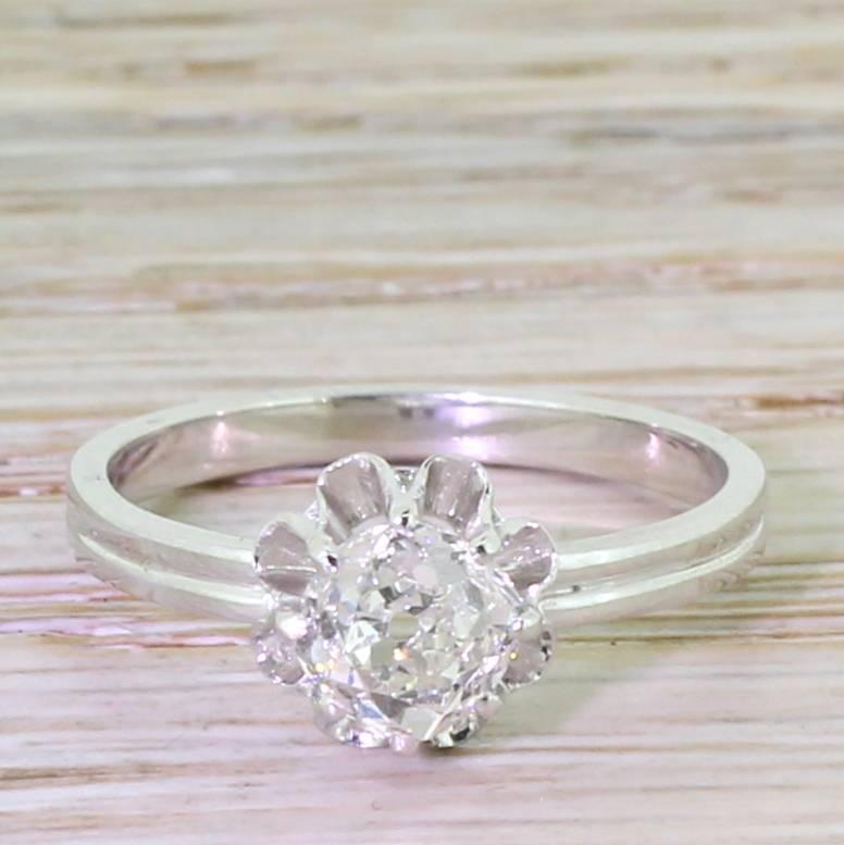 A quite striking old cut diamond solitaire engagement ring, in platinum, which we adapted from a pair of Edwardian earrings. The top part of the ring is from the early part of last century; we added a simple platinum band with a fluted detail which