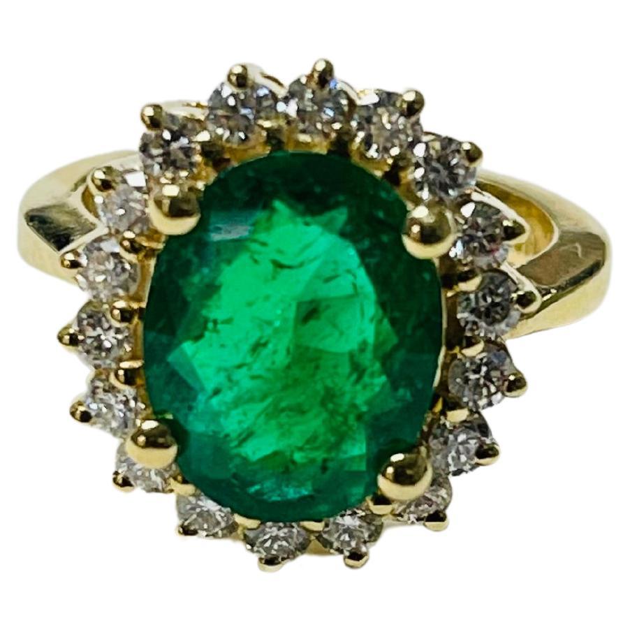Emerald Oval And Diamond Engagement Ring In 18 Karat Yellow Gold.