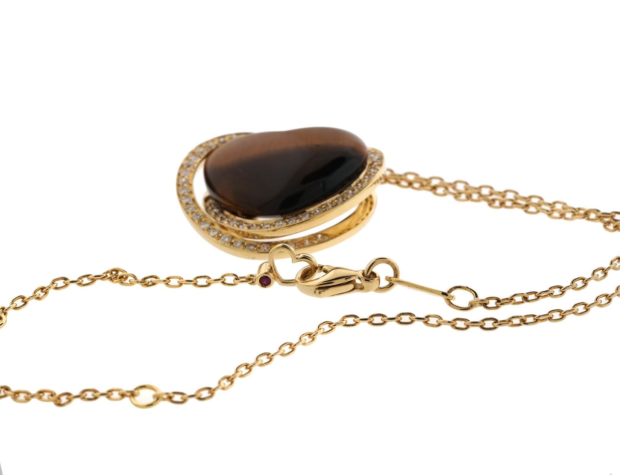Roberto Coin Tigers Eye, heart shaped pendant. The necklace weighs 7.70 dwt, has 56 round diamonds in G color, VS Clarity for a total weight of .70cts. The necklace is 18 inches in length. Pendant is approx 25 x 20 mm