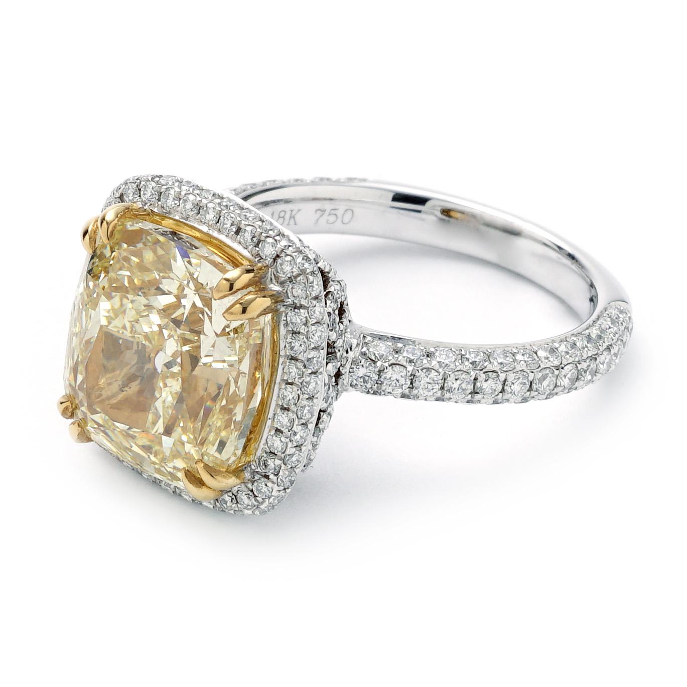 This Cushion pave Halo ring weighs 5.4 DWT (approx. 8.4 grams). It contains one GIA Certified cushion shaped fancy yellow, VS2 clarity diamond weighing 7.01 CTTW, 236 round G color and VS2-SI1 clarity diamonds weighing 1.11 CTTW. Ring is Size 6