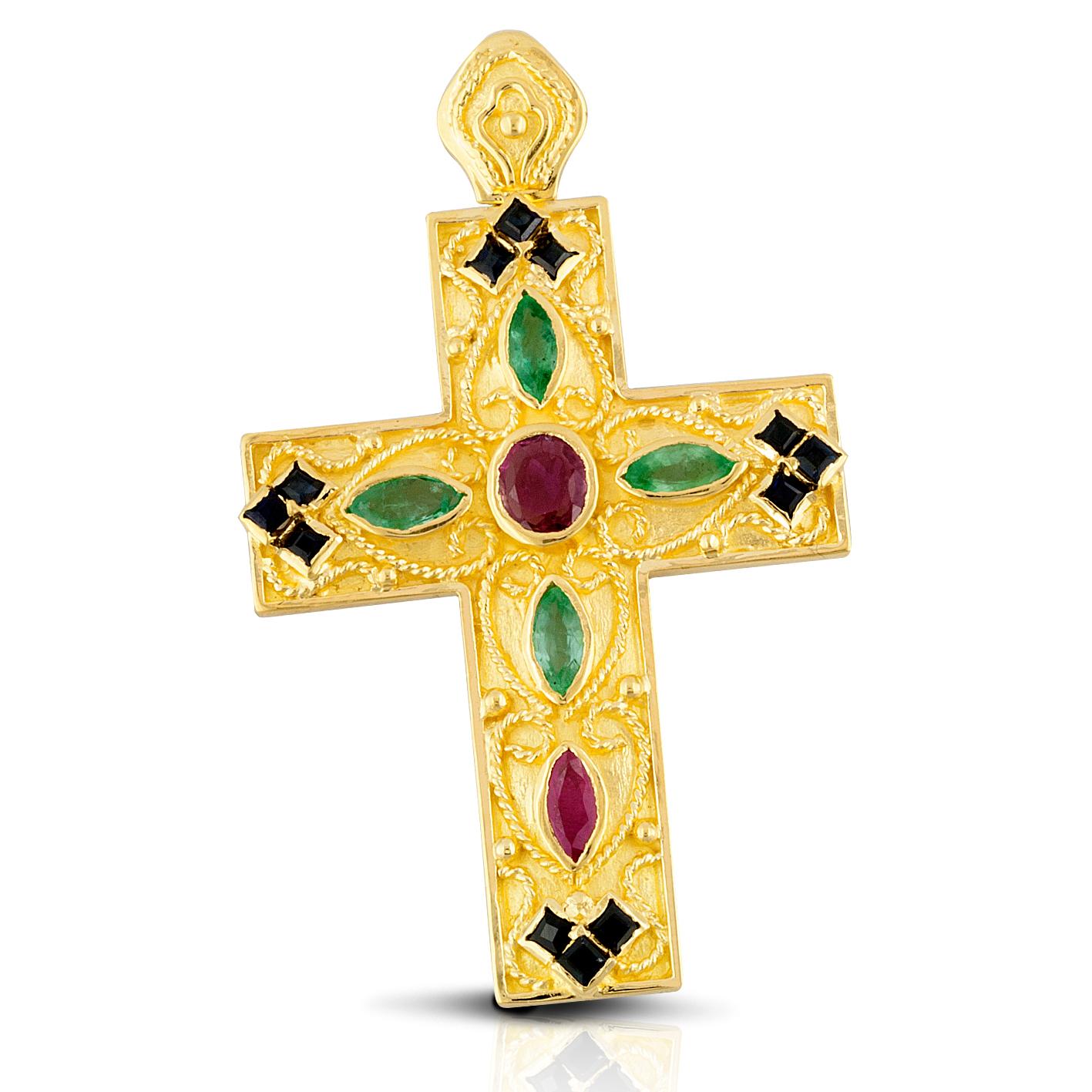 S.Georgios Byzantine Style Cross Pendant is handmade from solid 18 Karat Yellow Gold and features 2 Rubies, 4 Emeralds, and 12 Sapphire all total weight of 2,94 Carat. This stunning art piece is made as an inspiration from the Byzantine Museum in