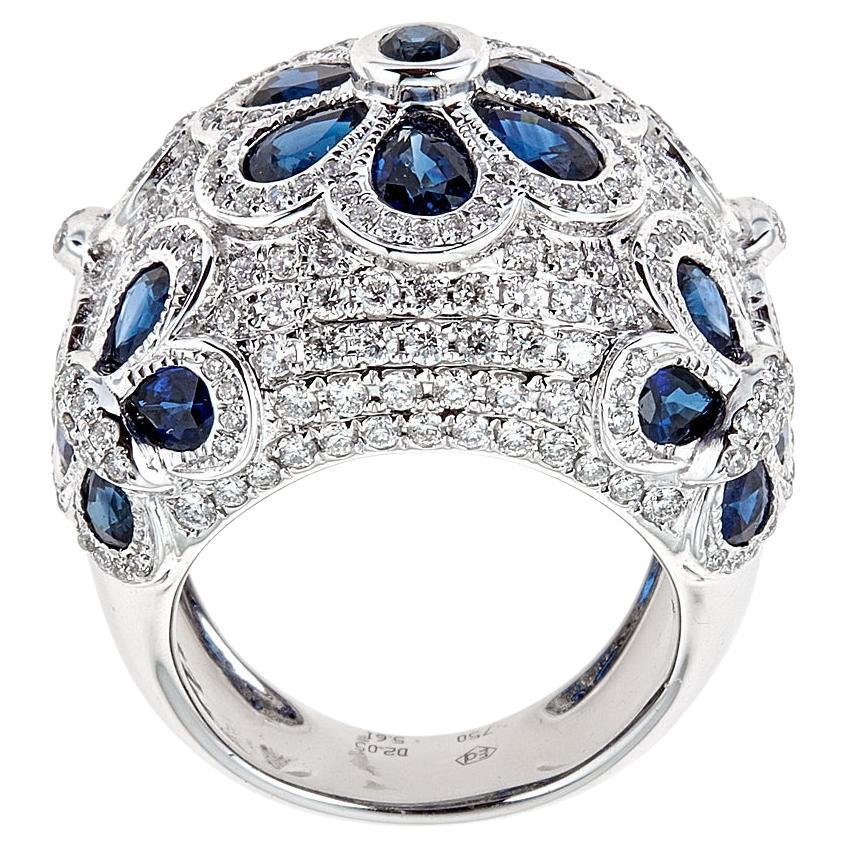 18 Karat White Gold 5.61 Carat Blue Sapphire and 2.05 Carat Diamond Cluster Ring Jewelry

Luxuriously stylish in every way, this cocktail ring is the fashion in a sleek 18k White Gold. Encrusted with pear and round shaped blue sapphires layered in a