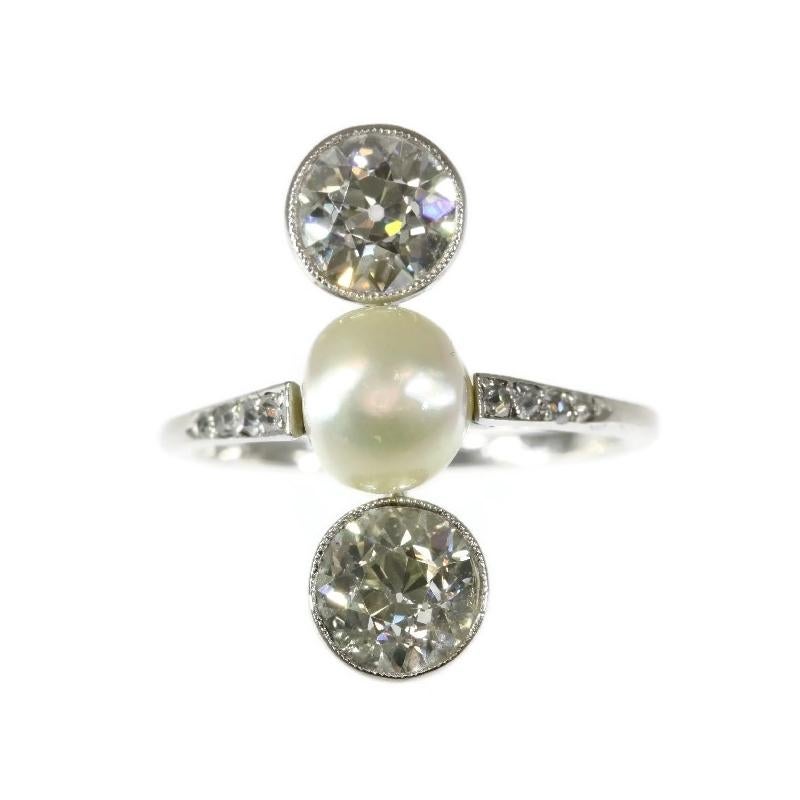 This platinum Art Deco inline ring is more than meets the eye.
The gleam of this natural pearl in its vertical sequence of two old brilliant cut diamonds shows the star alignment of a union meant to be.
However, no matter how this all may seem