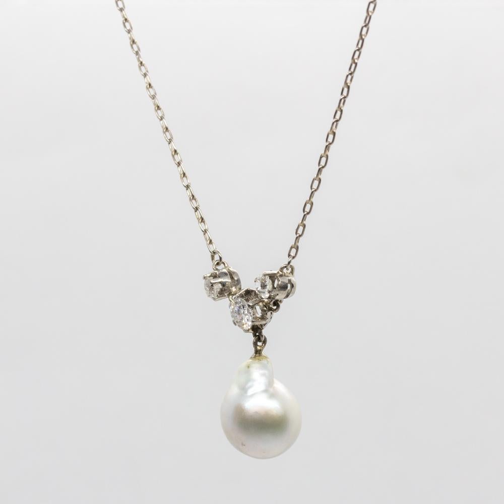 Period: Edwardian (1901-1920)
Composition: Platinum
Stones:
•	1 GIA Certified cultured pearl (10.13mm by 10.19mm.)
•	3 Old mine cut diamonds H-VS2 0.50ctw.
Pendant measure: 24mm by 10mm.
Pendant Thickness: 10mm.
Chain length: 47cm.
Total weight: 
