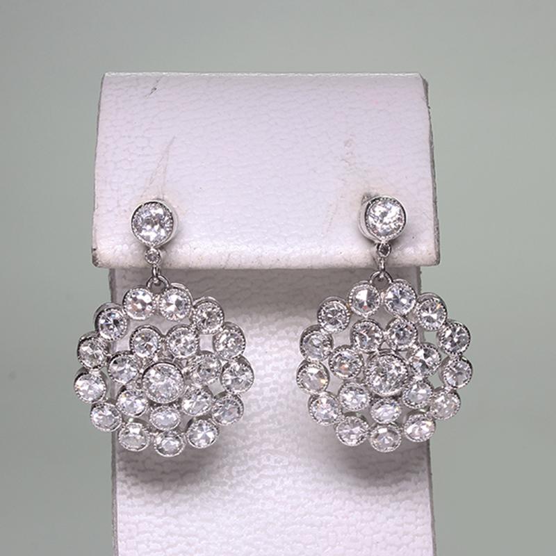 Period: Edwardian (1901-1920)
Composition: Platinum.
Stones: 
•	4 Old mine cut diamonds of H-VS2 quality that weigh 0.50ctw. 
•	42 Single cut diamonds of H-VS2/SI1 quality that weigh 2.40ctw. 
Earring measures: 22mm by 15mm
Thick: 5mm.
Total weight: