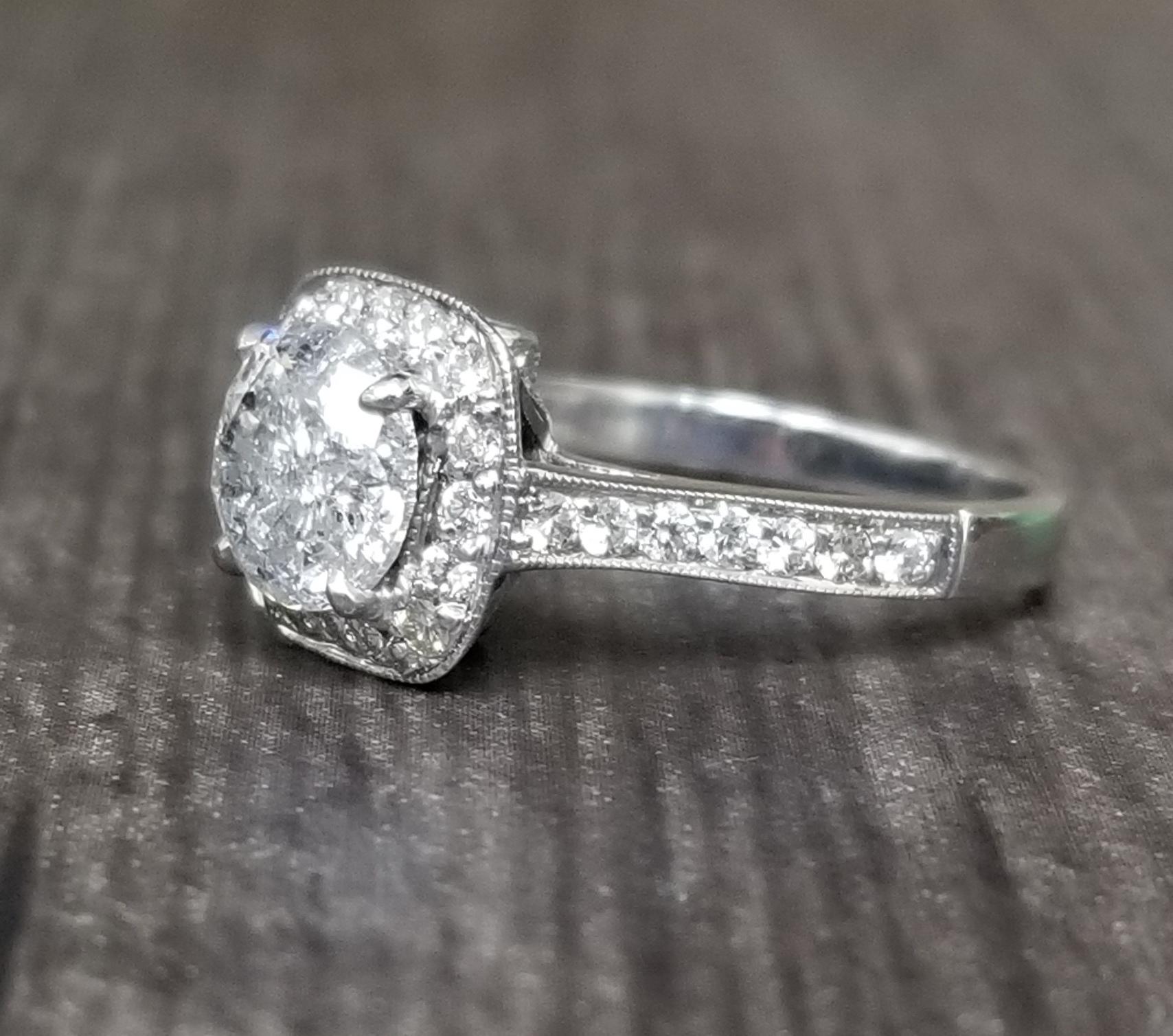 14k white gold ladies diamond halo ring containing 1 brilliant cut diamond; color 