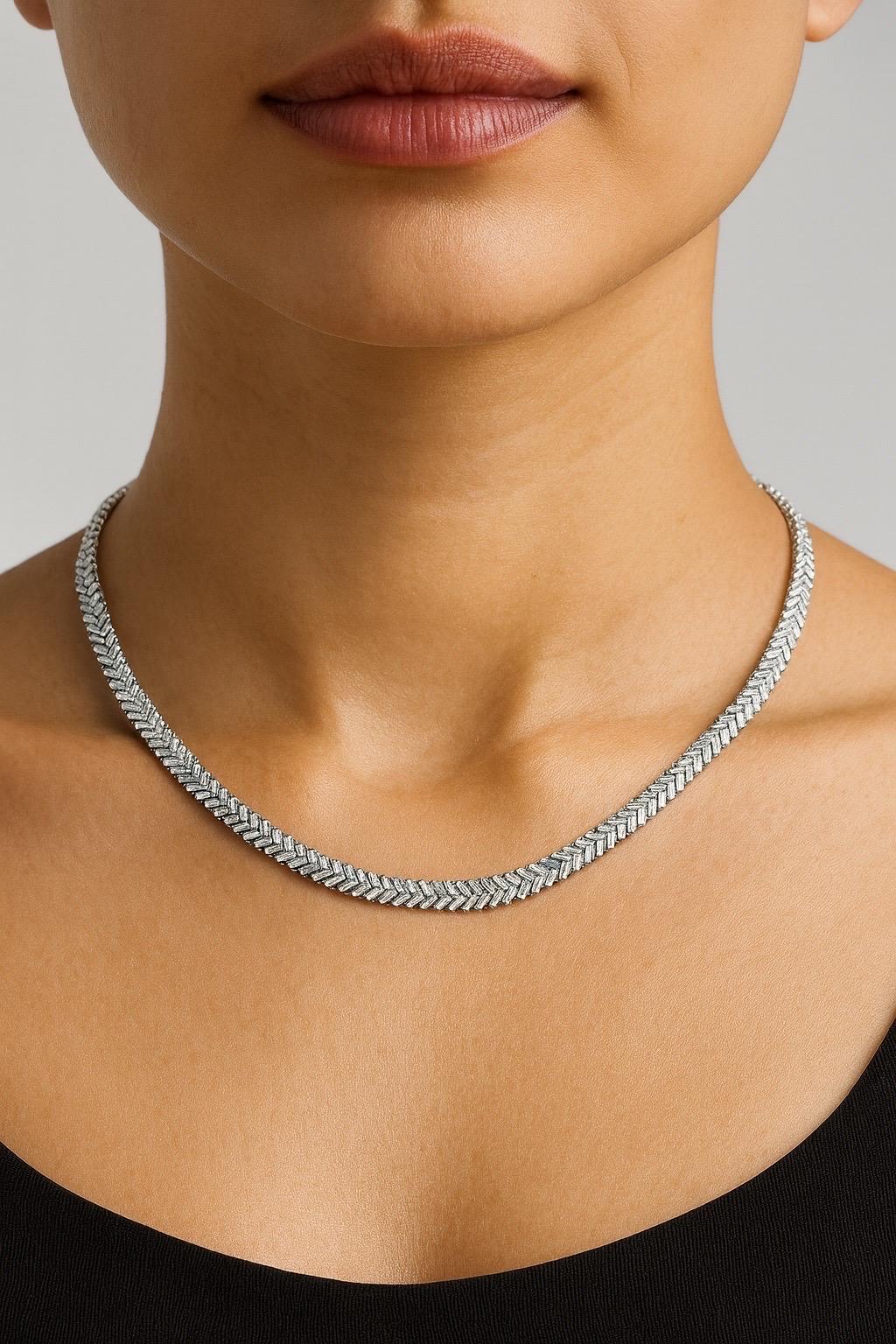 Cast from 14-karat gold, this exquisite necklace is handset with 7 carats of sparkling baguette diamonds. Length size 16-20.  Introducing a statement masterpiece: our stunning tennis necklace, a true testament to luxury and elegance. This exquisite