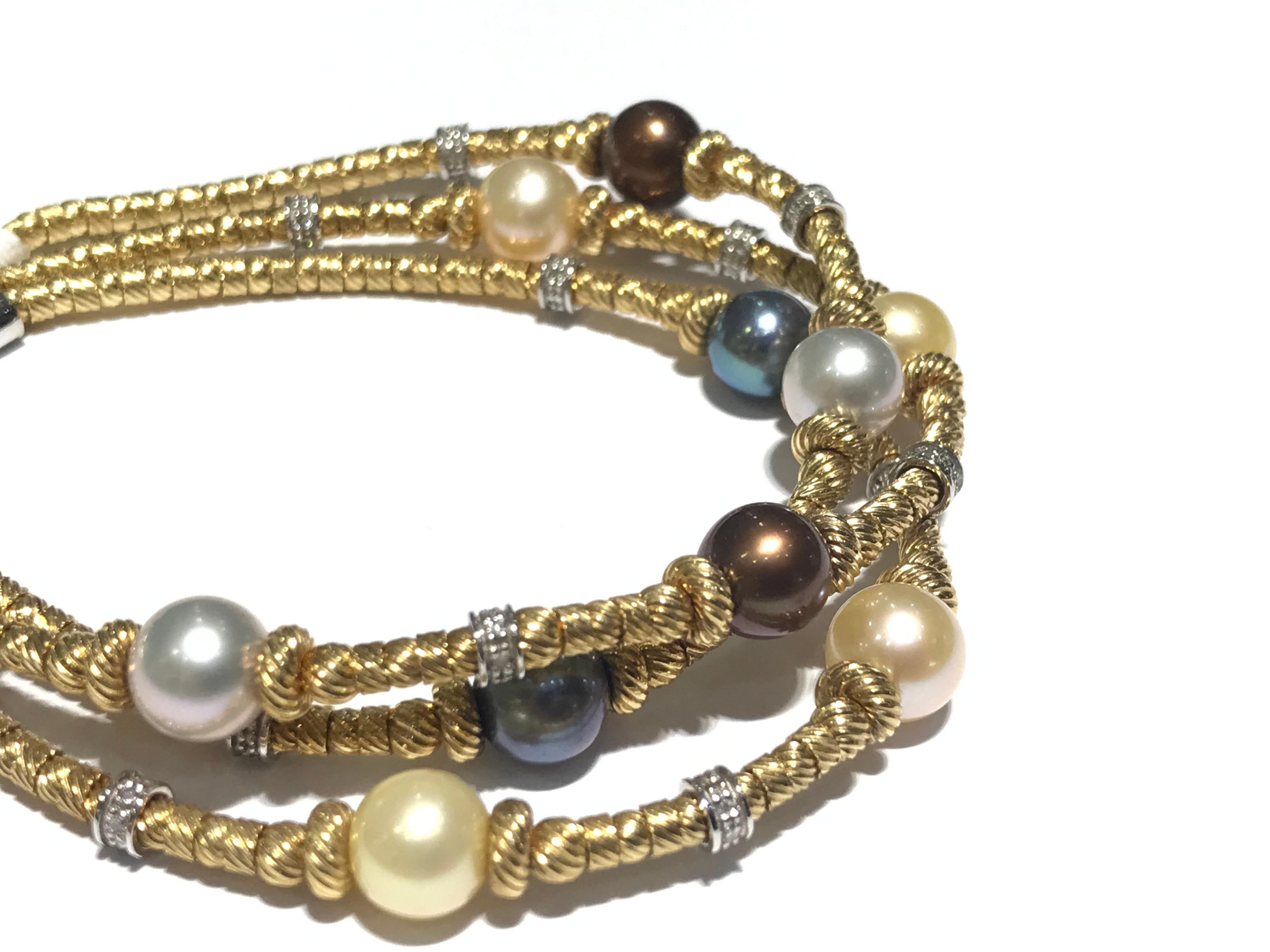 Cultured Pearl and diamond Bracelet in 18 karat y/g with 0.40 ct diamonds 
2 brown pearls
3 white pearls 
2 grey pearls 
2 black pearls
1 yellow pearl 