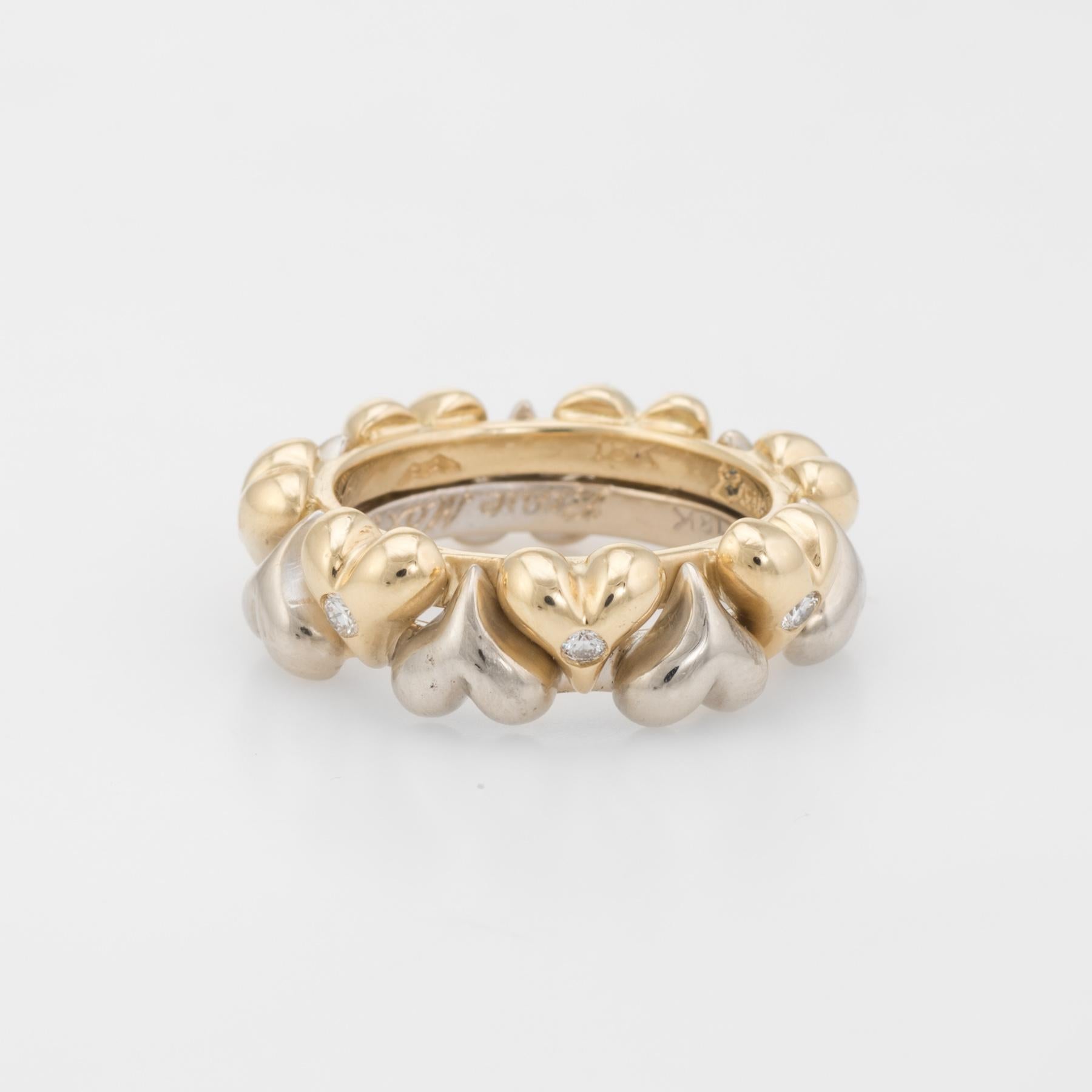 Distinct and unusual vintage hearts eternity ring, crafted in two tone 18 karat yellow & white gold. 

Round brilliant cut diamonds are set into the yellow gold hearts, totaling an estimated 0.07 carats (estimated at H-I color and VS2 clarity).