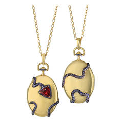 A Red Spinel, Purple Sapphire and Gold Snake Locket by Monica Rich Kosann